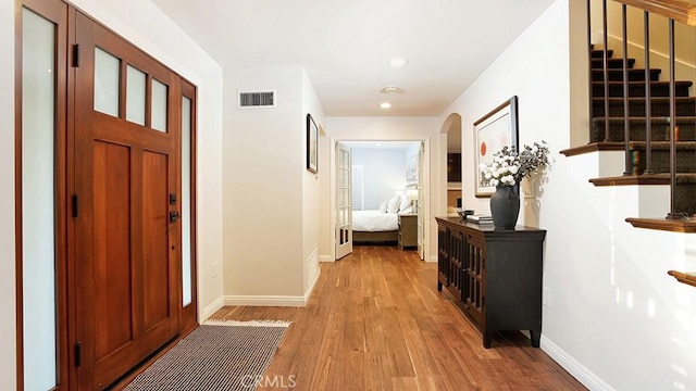 31962 Via Montura, San Juan Capistrano, CA 92675 - entrance foyer with light wood-style flooring, arched walkways, recessed lighting, and stairs