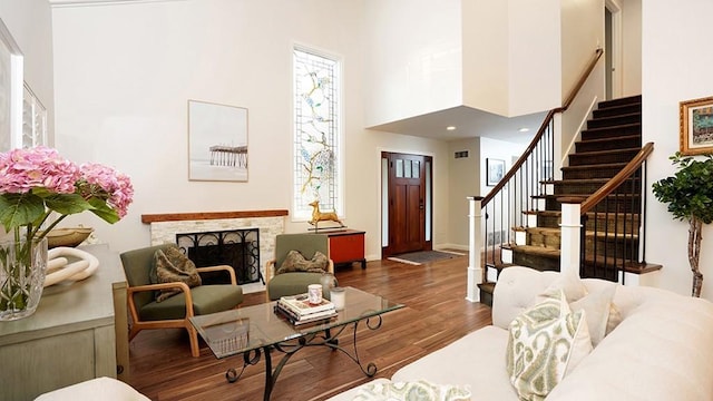 31962 Via Montura, San Juan Capistrano, CA 92675 - living room featuring stairway, wood finished floors, a high ceiling, and a fireplace