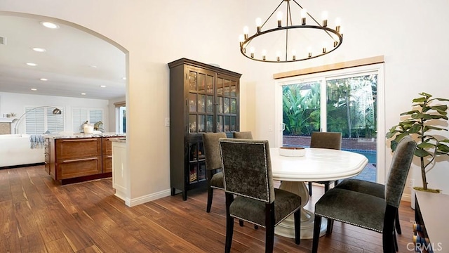 31962 Via Montura, San Juan Capistrano, CA 92675 - dining space featuring dark wood finished floors, arched walkways, recessed lighting, and a chandelier