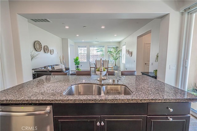 24270 Verdugo Cir, Valencia, CA 91354 - kitchen with dishwasher, open floor plan, dark stone countertops, a center island with sink, and dark brown cabinets