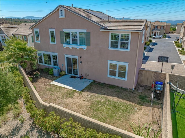 24270 Verdugo Cir, Valencia, CA 91354 - rear view of house featuring stucco siding, a tiled roof, a fenced backyard, and a patio area
