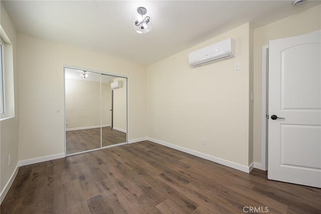 4548 Jade St, Los Angeles, CA 90032 - unfurnished bedroom with a wall unit AC, wood finished floors, and a closet