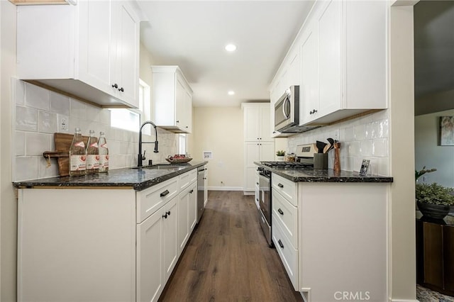 4548 Jade St, Los Angeles, CA 90032 - kitchen with stainless steel appliances, dark wood-style floors, recessed lighting, white cabinetry, and decorative backsplash