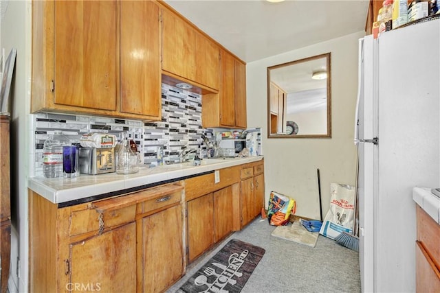 120 Alamitos Ave Unit 14, Long Beach, CA 90802 - kitchen with freestanding refrigerator, decorative backsplash, carpet flooring, tile counters, and brown cabinets