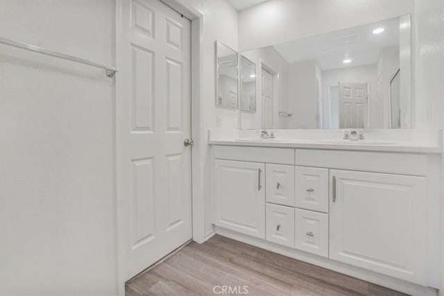 12956 9th Ave, Victorville, CA 92395 - bathroom with double vanity, wood finished floors, and recessed lighting