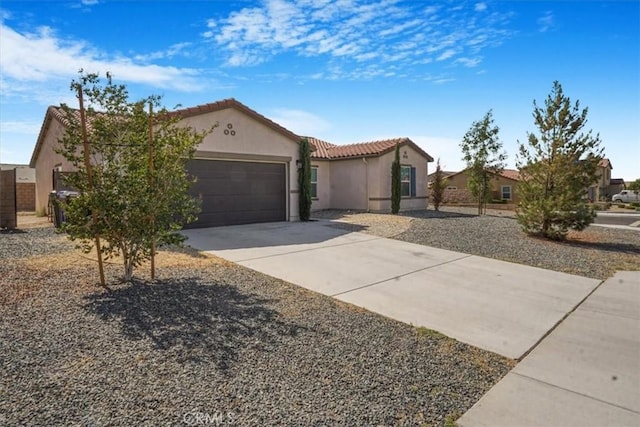 12956 9th Ave, Victorville, CA 92395 - mediterranean / spanish house with stucco siding, a tiled roof, concrete driveway, and a garage