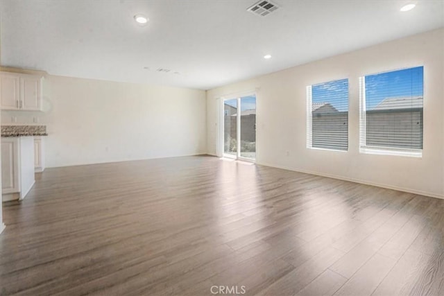12956 9th Ave, Victorville, CA 92395 - unfurnished living room featuring wood finished floors and recessed lighting