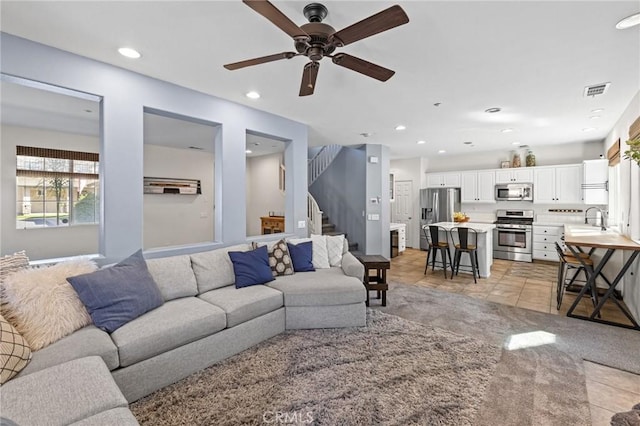 11317 Riverleaf Dr, Riverside, CA 92505 - living room with ceiling fan, light tile patterned flooring, stairs, and recessed lighting