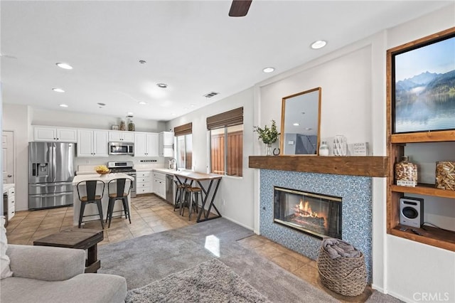 11317 Riverleaf Dr, Riverside, CA 92505 - living area with light tile patterned flooring, recessed lighting, and a fireplace