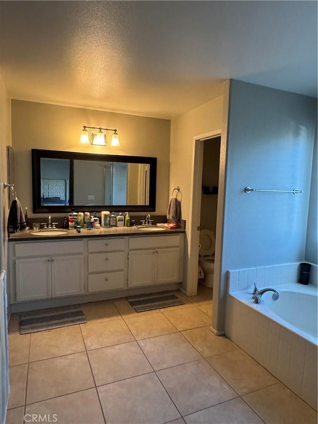32555 Via Perales, Temecula, CA 92592 - full bathroom featuring double vanity, a garden tub, tile patterned floors, and a textured ceiling