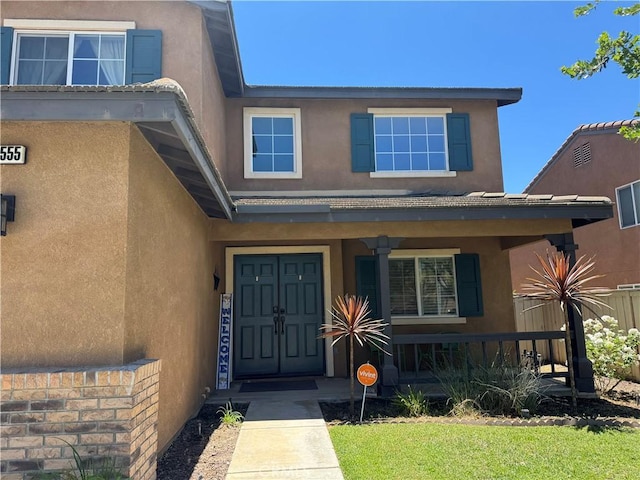 32555 Via Perales, Temecula, CA 92592 - doorway to property featuring a porch and stucco siding
