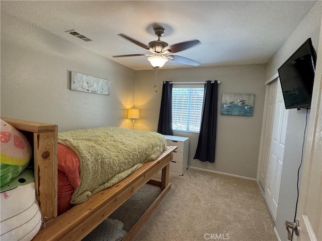 32555 Via Perales, Temecula, CA 92592 - bedroom featuring light colored carpet, a textured ceiling, a closet, and ceiling fan