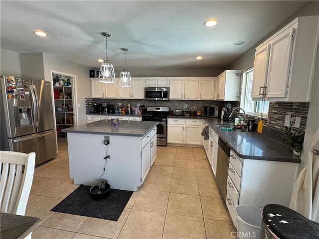 32555 Via Perales, Temecula, CA 92592 - kitchen with appliances with stainless steel finishes, dark countertops, a center island, backsplash, and recessed lighting