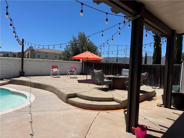 32555 Via Perales, Temecula, CA 92592 - fenced backyard featuring a patio area and a fire pit