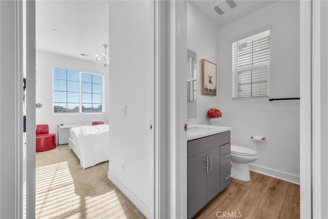 2123 Crescent Moon, Upland, CA 91786 - bathroom featuring vanity, plenty of natural light, and wood finished floors