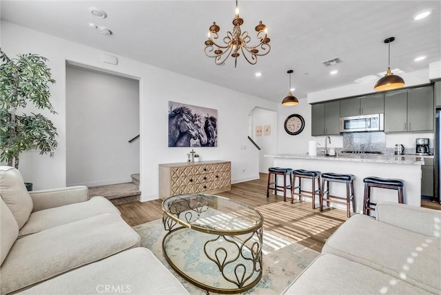 2123 Crescent Moon, Upland, CA 91786 - living room featuring a chandelier, recessed lighting, light wood-style flooring, and stairway