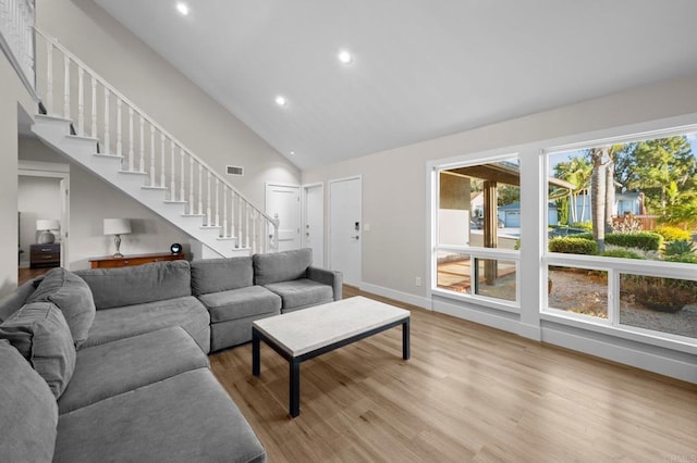 11052 Madrigal St, San Diego, CA 92129 - living room featuring plenty of natural light, stairs, light wood-type flooring, high vaulted ceiling, and recessed lighting
