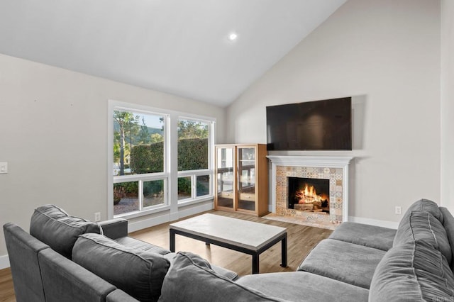 11052 Madrigal St, San Diego, CA 92129 - living room with high vaulted ceiling, wood finished floors, a fireplace, and recessed lighting