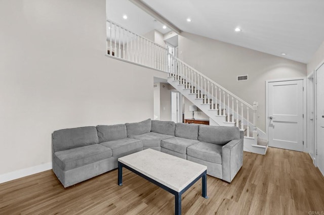 11052 Madrigal St, San Diego, CA 92129 - living room with stairway, light wood finished floors, recessed lighting, and high vaulted ceiling