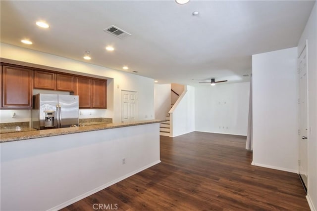 44939 Bellflower Ln Unit 118, Temecula, CA 92592 - kitchen featuring stainless steel refrigerator with ice dispenser, brown cabinetry, recessed lighting, dark wood-type flooring, and light stone counters