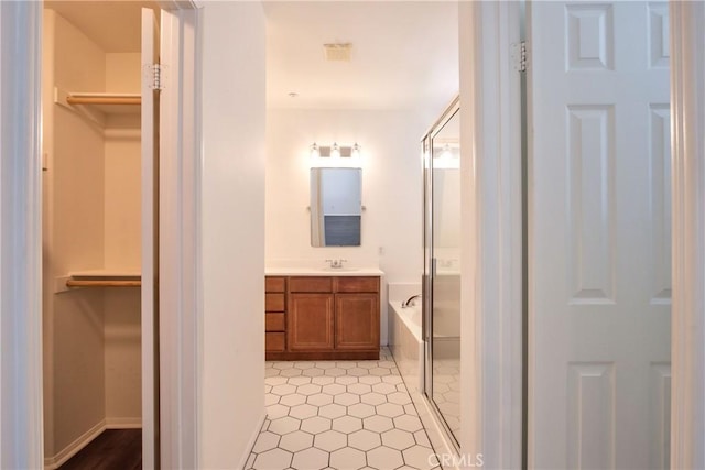 44939 Bellflower Ln Unit 118, Temecula, CA 92592 - bathroom with vanity, a bath, a spacious closet, and tile patterned floors