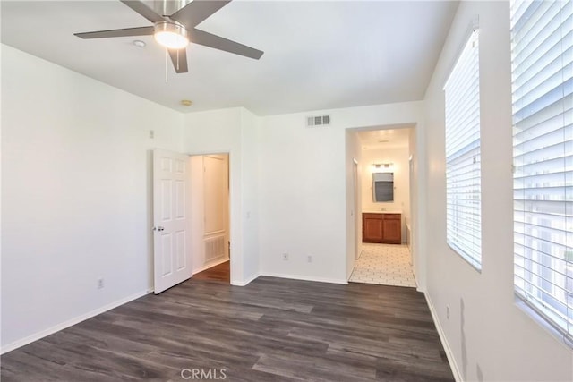 44939 Bellflower Ln Unit 118, Temecula, CA 92592 - unfurnished bedroom featuring dark wood-style floors, multiple windows, ensuite bath, and a ceiling fan