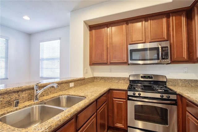 44939 Bellflower Ln Unit 118, Temecula, CA 92592 - kitchen with stainless steel appliances, light stone counters, recessed lighting, and brown cabinetry