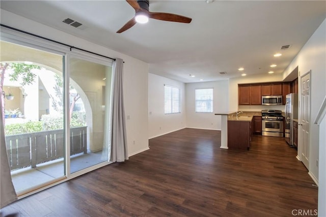 44939 Bellflower Ln Unit 118, Temecula, CA 92592 - kitchen with appliances with stainless steel finishes, dark wood-style floors, a ceiling fan, open floor plan, and light countertops