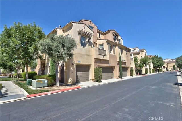 44939 Bellflower Ln Unit 118, Temecula, CA 92592 - view of asphalt road featuring a residential view and curbs