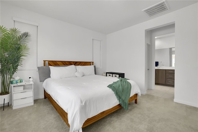 26149 Park Ave Unit 38, Loma Linda, CA 92354 - bedroom with light colored carpet and connected bathroom