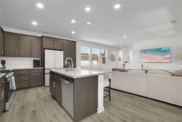 26149 Park Ave Unit 38, Loma Linda, CA 92354 - kitchen with stainless steel appliances, open floor plan, dark brown cabinets, light wood-type flooring, and recessed lighting