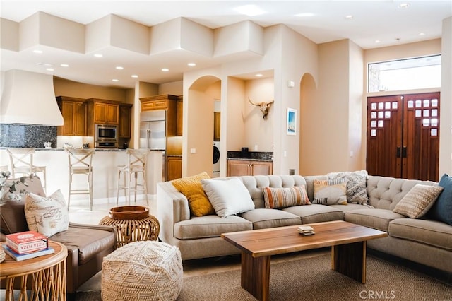 46614 Bradshaw Trl, La Quinta, CA 92253 - living room with arched walkways, washer / dryer, and recessed lighting