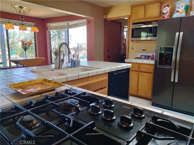 2390 Trinity Rd, Pinon Hills, CA 92372 - kitchen with black appliances, tile countertops, and pendant lighting