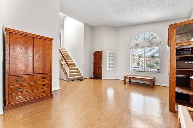 19080 Shakespeare Dr, Walnut, CA 91789 - entrance foyer featuring light wood-style flooring, stairs, and a textured ceiling