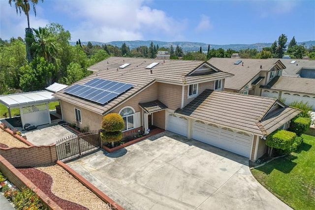19080 Shakespeare Dr, Walnut, CA 91789 - view of front facade featuring a gate, solar panels, concrete driveway, a garage, and a mountain view