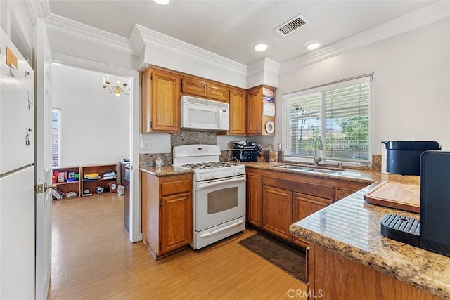 19080 Shakespeare Dr, Walnut, CA 91789 - kitchen featuring white appliances, brown cabinetry, light wood-style floors, ornamental molding, and recessed lighting