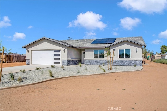 10533 Mohawk Rd, Apple Valley, CA 92308 - ranch-style house featuring stone siding, stucco siding, solar panels, and an attached garage