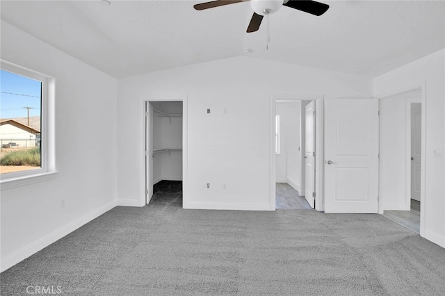 10533 Mohawk Rd, Apple Valley, CA 92308 - unfurnished bedroom featuring carpet floors, vaulted ceiling, a walk in closet, ceiling fan, and connected bathroom