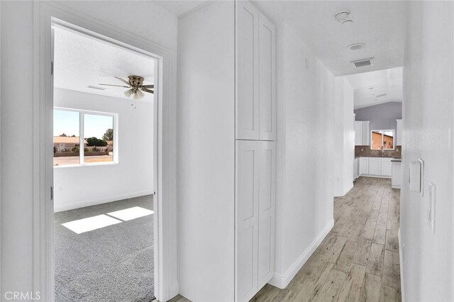 10533 Mohawk Rd, Apple Valley, CA 92308 - corridor with baseboards and light wood-style flooring