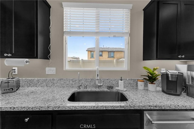 1511 Asteroid Way, Beaumont, CA 92223 - kitchen with dark cabinets, dishwasher, and light stone counters