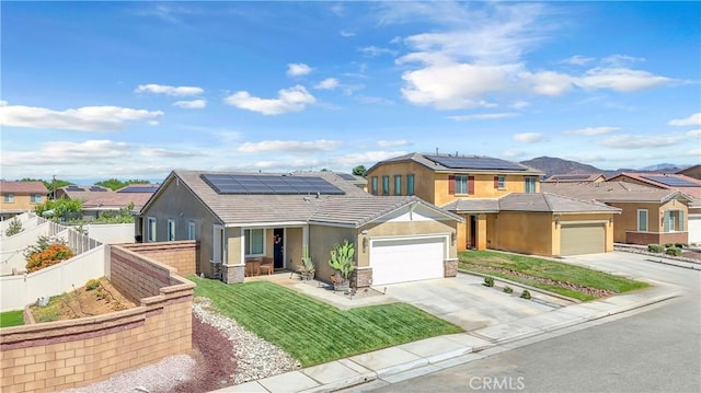 1511 Asteroid Way, Beaumont, CA 92223 - view of front facade featuring stucco siding, driveway, roof mounted solar panels, a garage, and a residential view