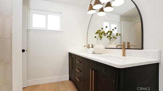 3073 N Pinewood St, Orange, CA 92865 - full bath featuring a chandelier, double vanity, healthy amount of natural light, and wood finished floors