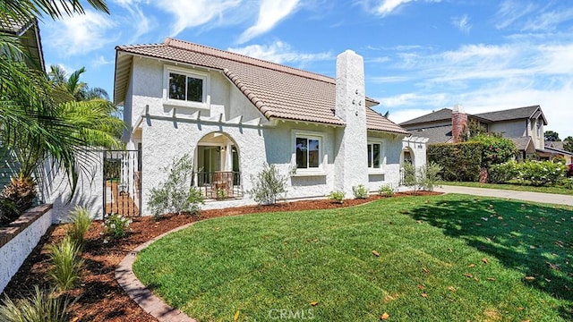 3073 N Pinewood St, Orange, CA 92865 - view of front facade with stucco siding, a front lawn, a chimney, and a tiled roof
