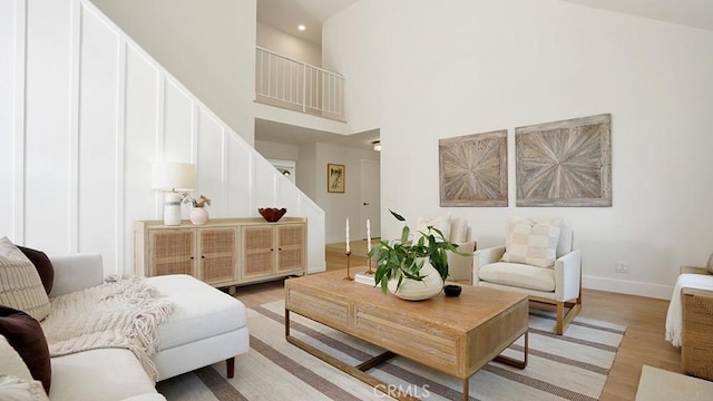 3073 N Pinewood St, Orange, CA 92865 - living area featuring stairs, a high ceiling, light wood-type flooring, and recessed lighting