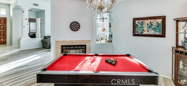 1020 La Salle Cir, Corona, CA 92879 - playroom featuring decorative columns, a premium fireplace, wood finished floors, a chandelier, and pool table