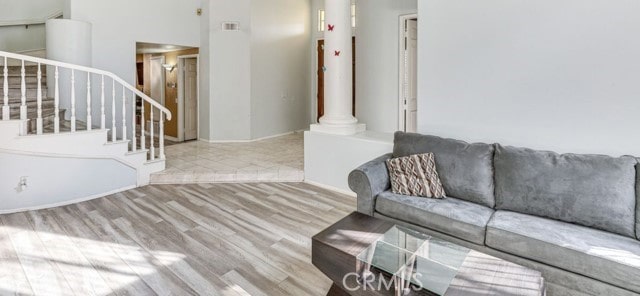 1020 La Salle Cir, Corona, CA 92879 - living room featuring wood finished floors, stairs, and decorative columns