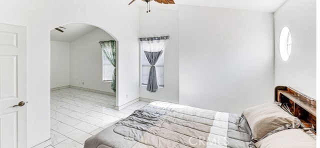 1020 La Salle Cir, Corona, CA 92879 - bedroom featuring light marble finish flooring, arched walkways, and a ceiling fan