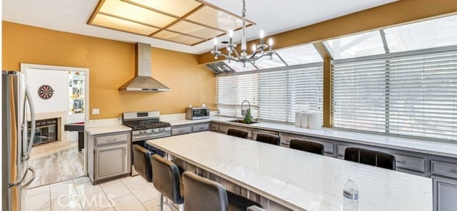 1020 La Salle Cir, Corona, CA 92879 - kitchen featuring wall chimney range hood, stainless steel appliances, gray cabinets, a chandelier, and light countertops