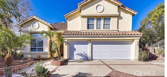 1020 La Salle Cir, Corona, CA 92879 - mediterranean / spanish home with a tiled roof, concrete driveway, an attached garage, and stucco siding