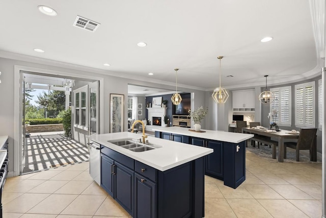 6257 Alverton, Carlsbad, CA 92009 - kitchen featuring a center island with sink, blue cabinets, open floor plan, light countertops, and crown molding